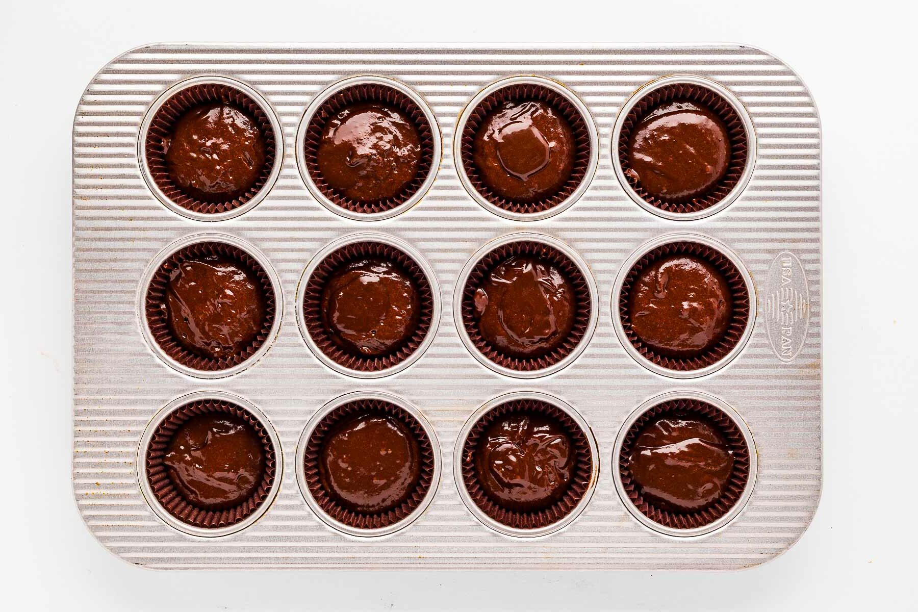 overhead view of cupcake liners filled with chocolate cupcake batter