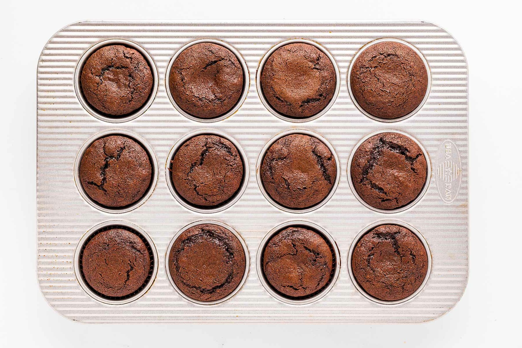 overhead view of baked chocolate cupcakes in cupcake pan