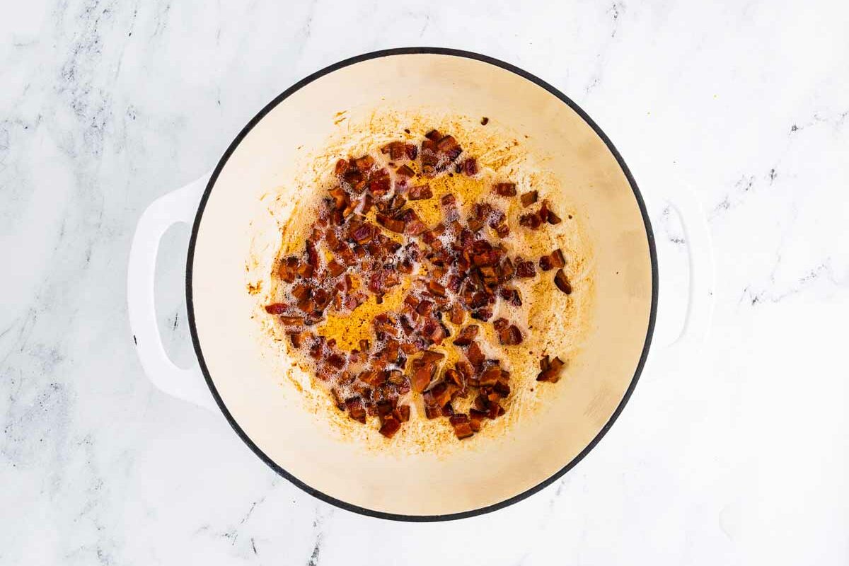 overhead view of crispy bacon pieces in a pot