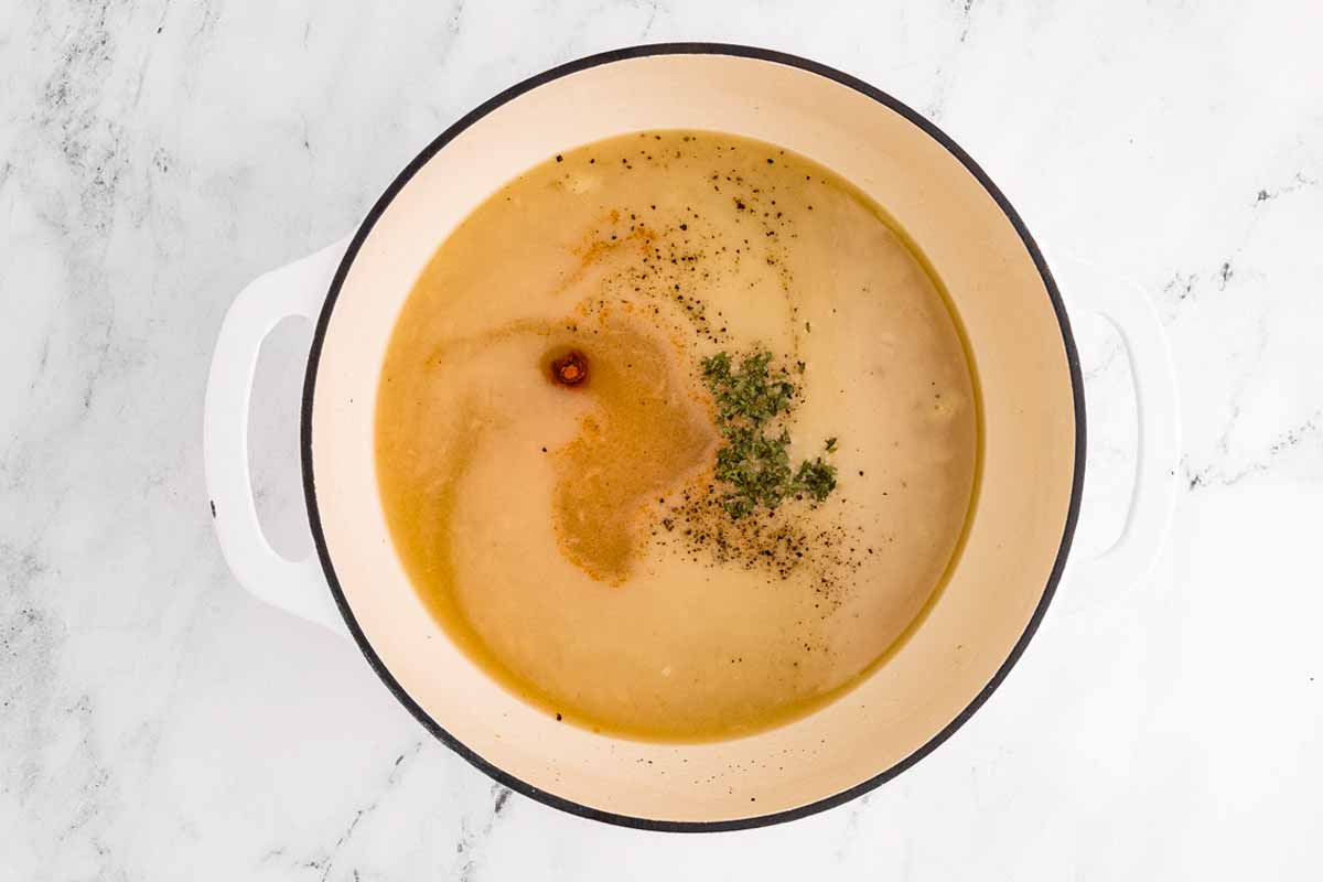 overhead view of uncooked potato soup in pot