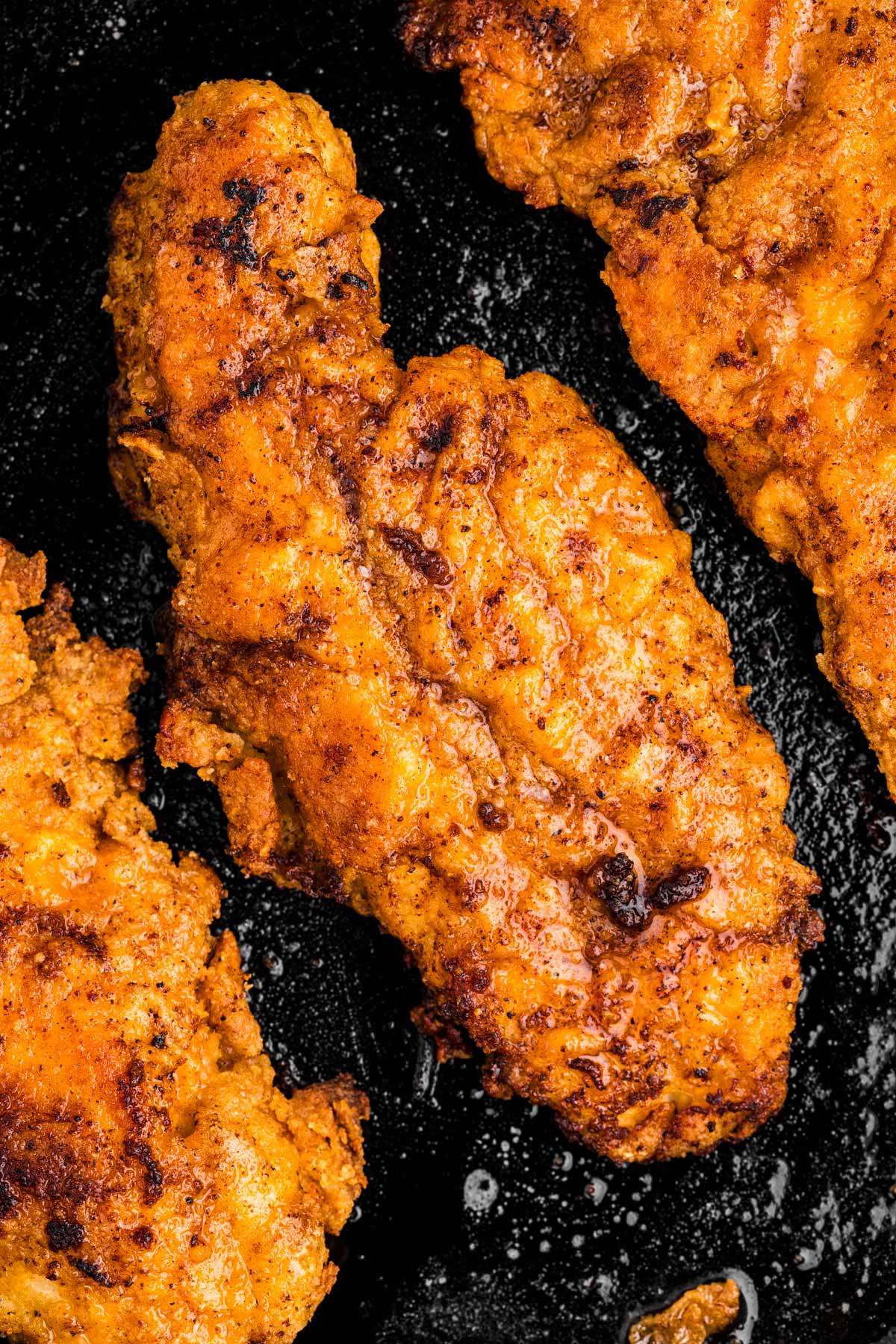 overhead close up view of fried chicken piece