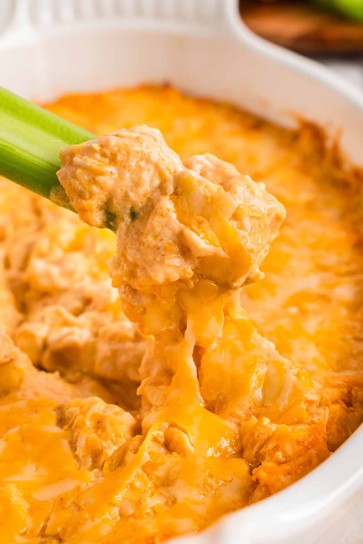 frontal close up of buffalo chicken dip on celery stick