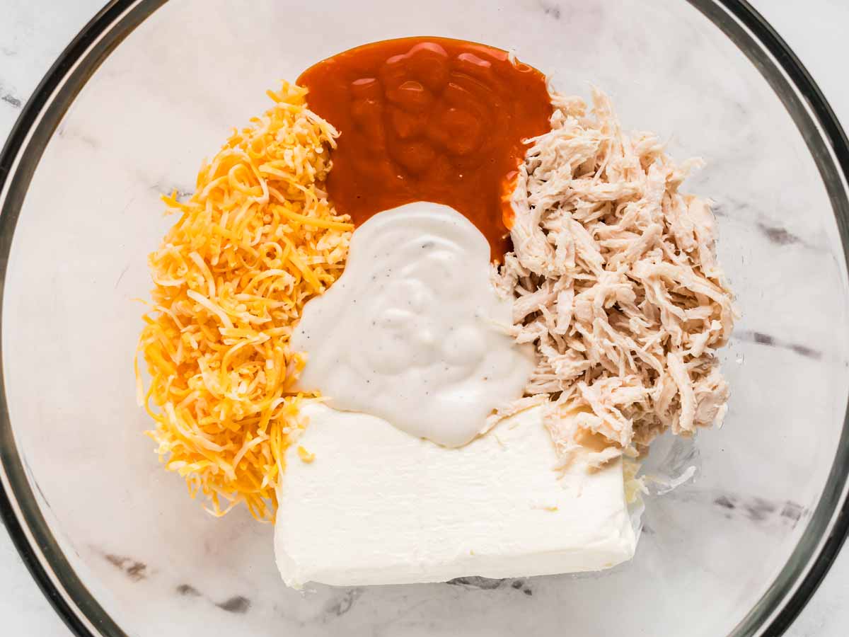 overhead view of ingredients for buffalo chicken dip in bowl