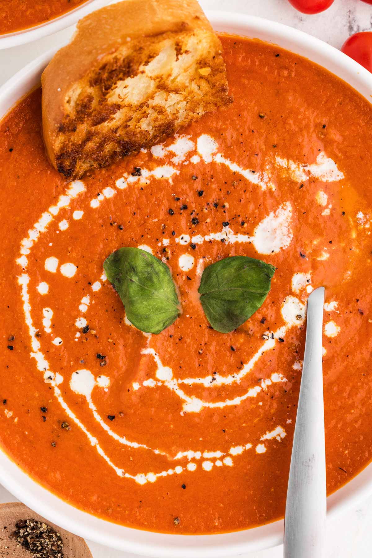 overhead close up view of tomato soup in white bowl