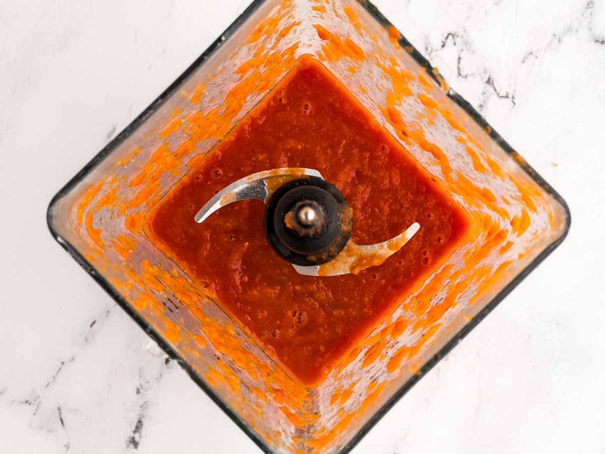 overhead view of blended tomato soup in blender cup