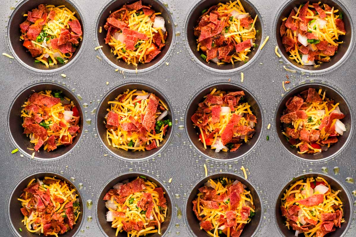 overhead view of muffin cups filled with cheese and bacon