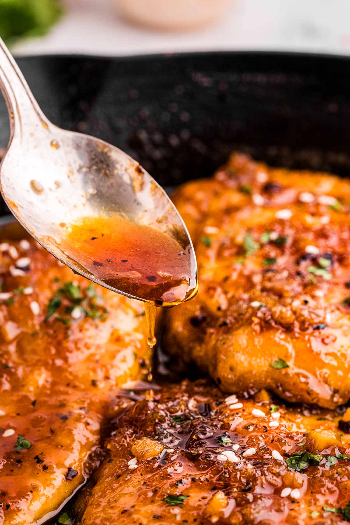 frontal view of honey garlic sauce drizzling over chicken