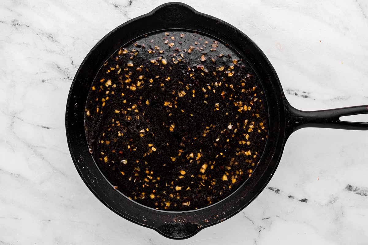 overhead view of honey garlic sauce in cast iron skillet