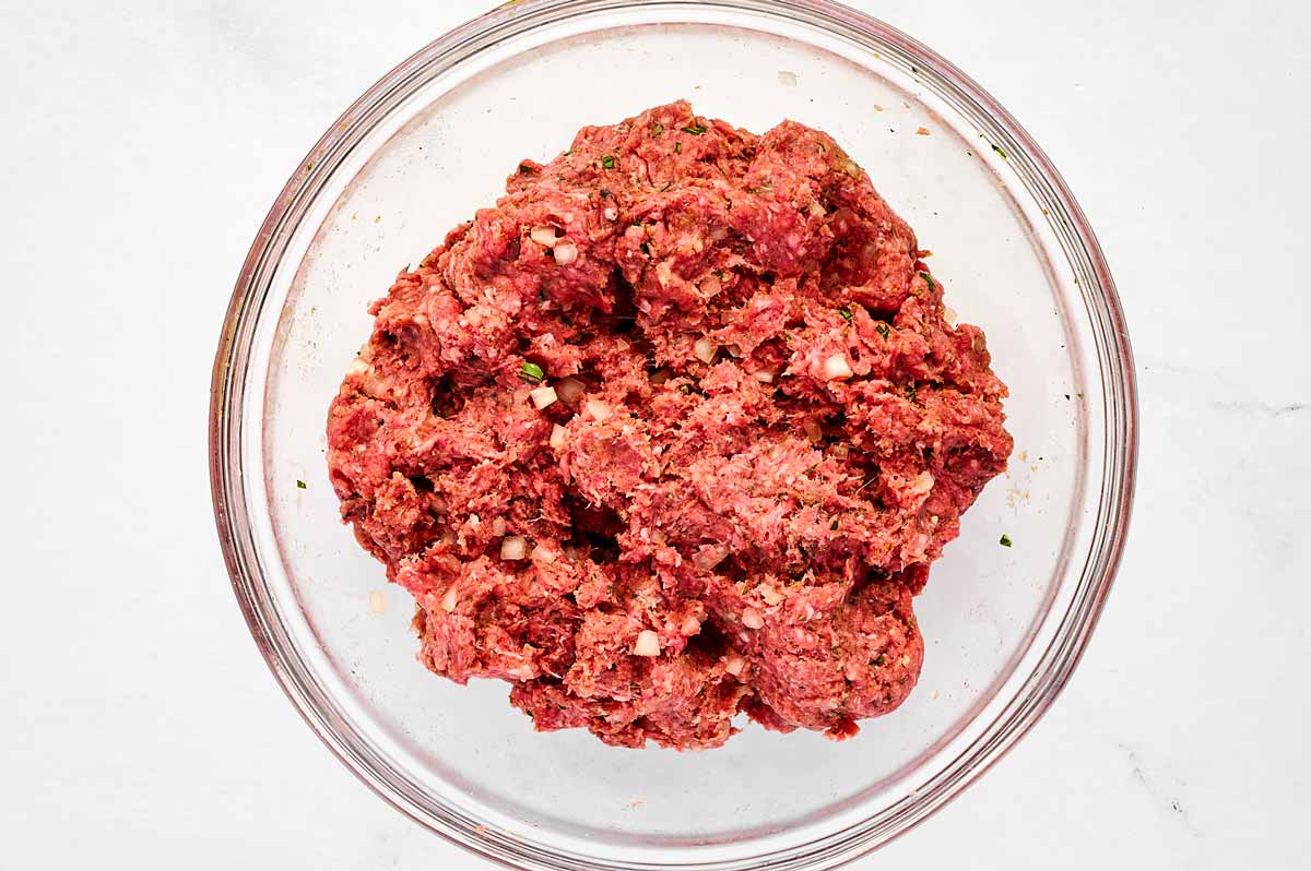 overhead view of meatball mixture in glass bowl