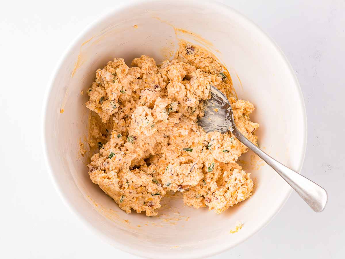 overhead view of seasoned cream cheese filling in white bowl