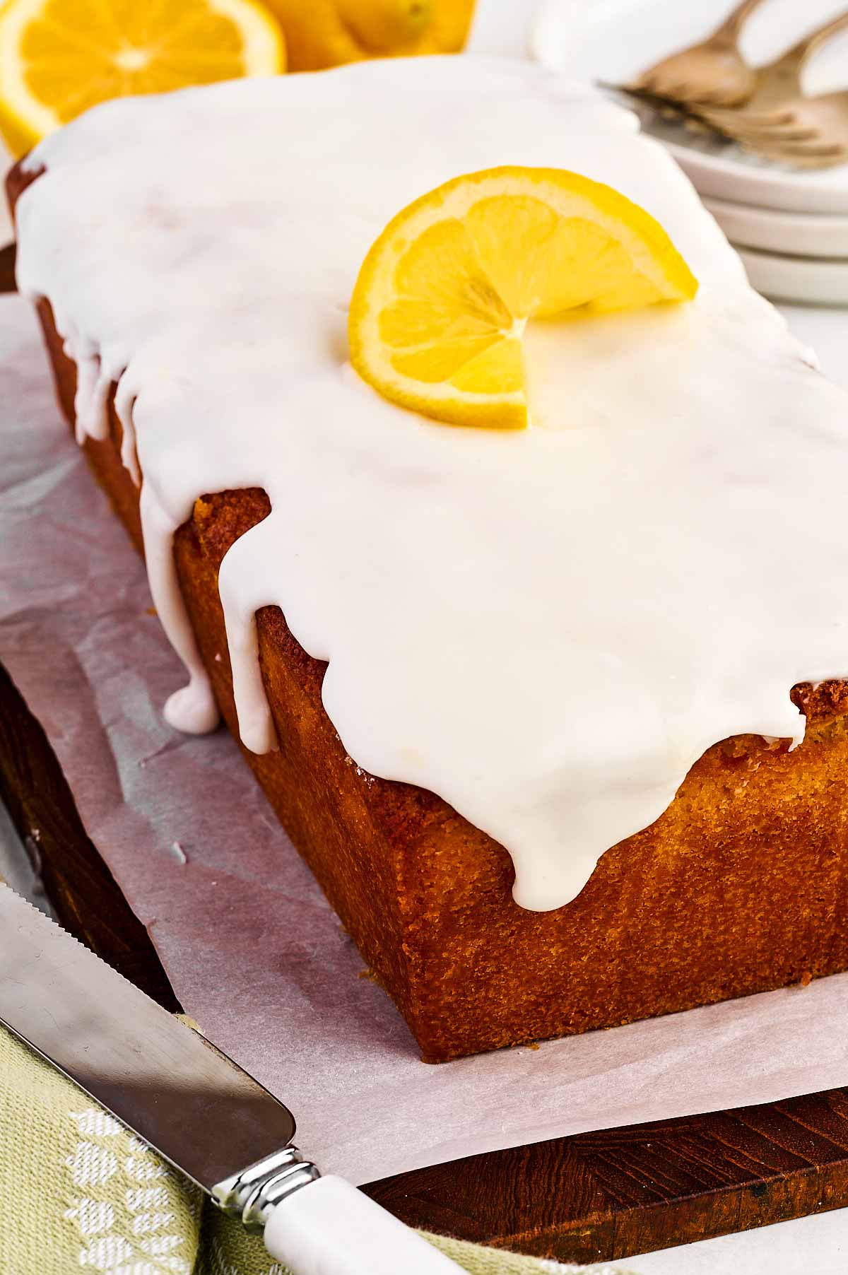 frontal view of lemon loaf pound cake with lemon glaze