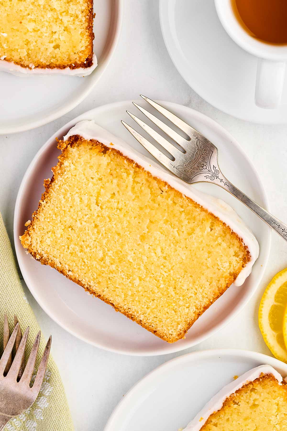 overhead view of lemon loaf pound cake slice on white plate