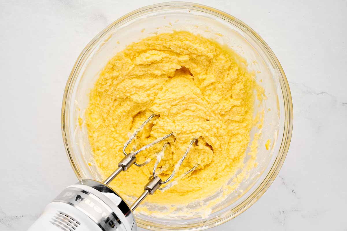 overhead view of creamed cake ingredients in bowl