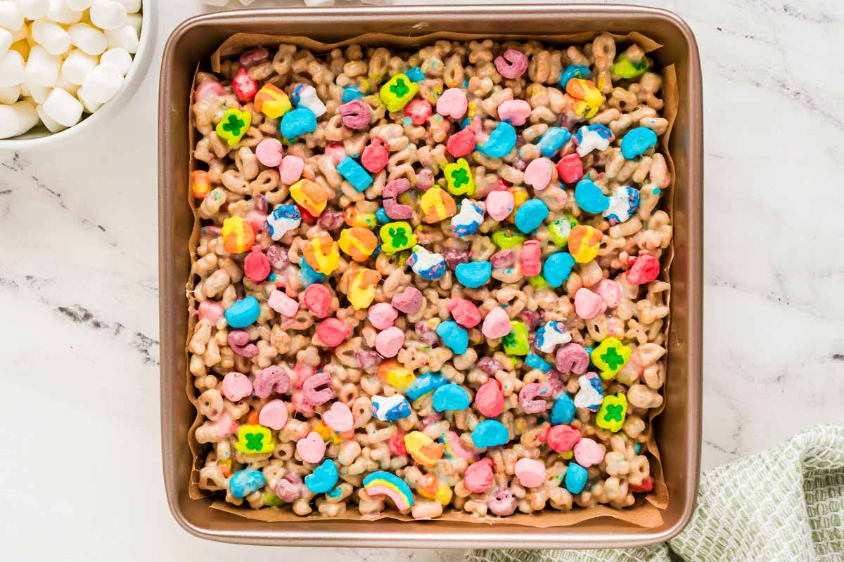 overhead view of lucky charms bar mixture in square pan