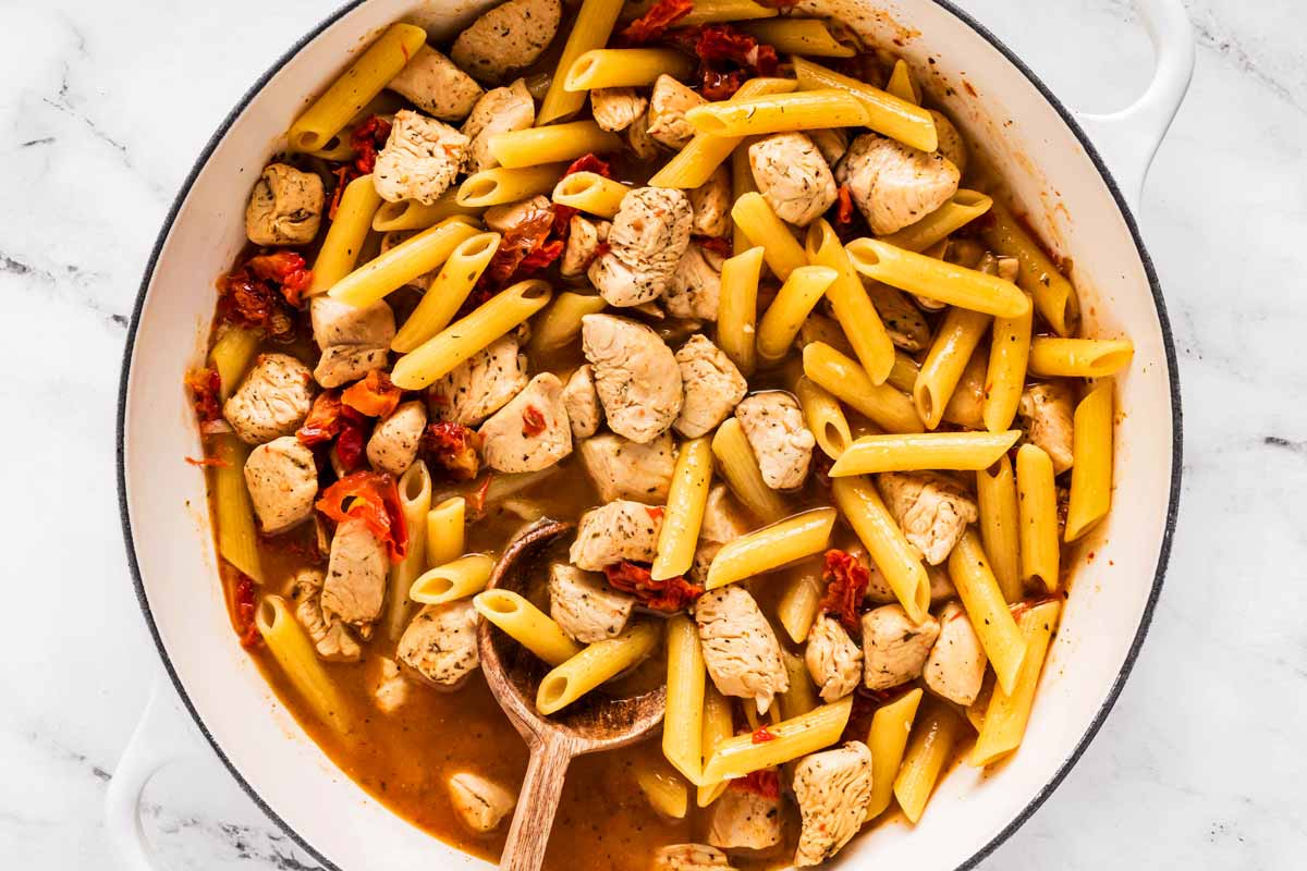 overhead view of uncooked marry me chicken pasta in pot