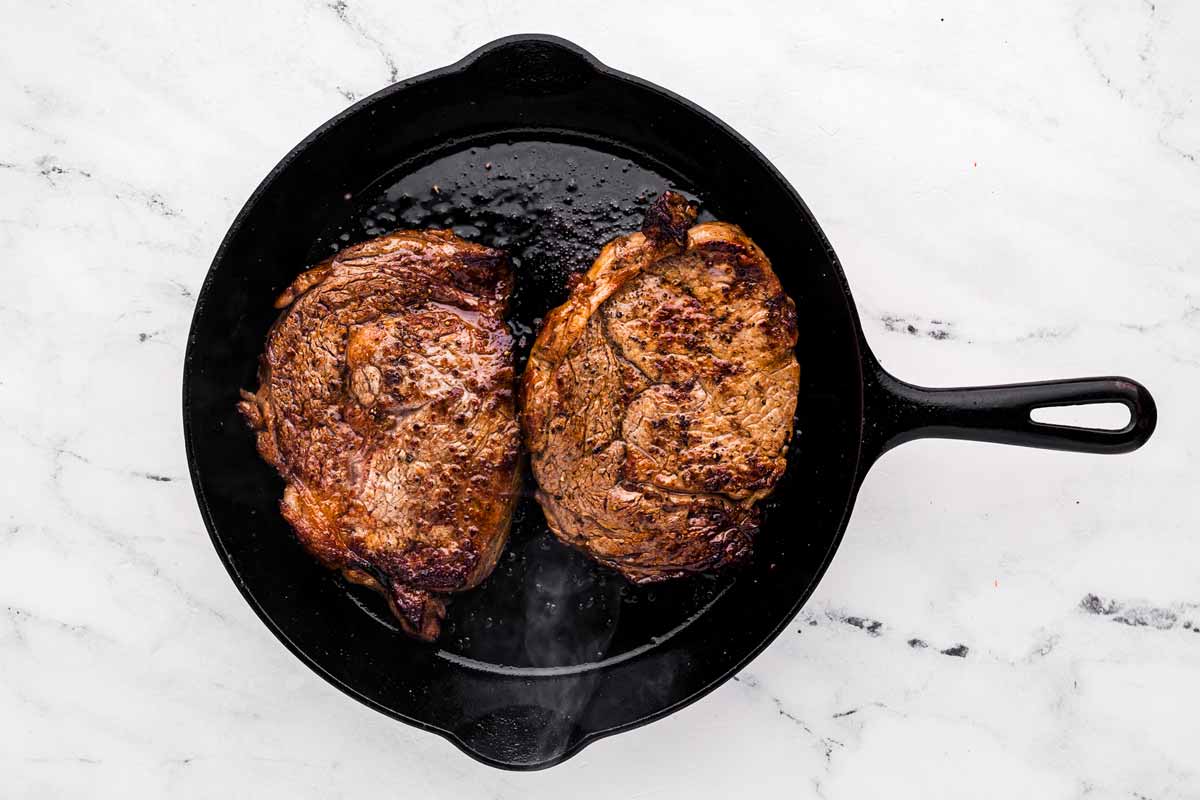 overhead view of seared steak in skillet