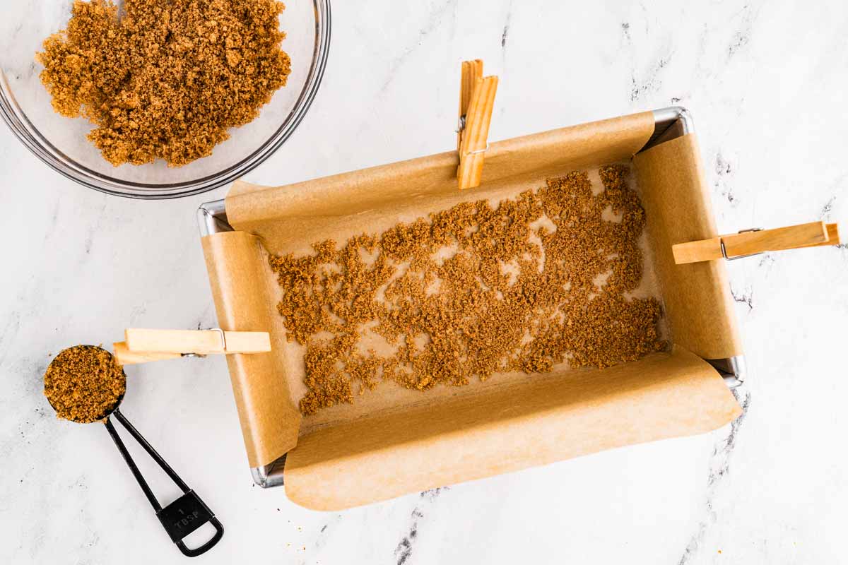 overhead view of lined loaf pan sprinkled with cinnamon sugar