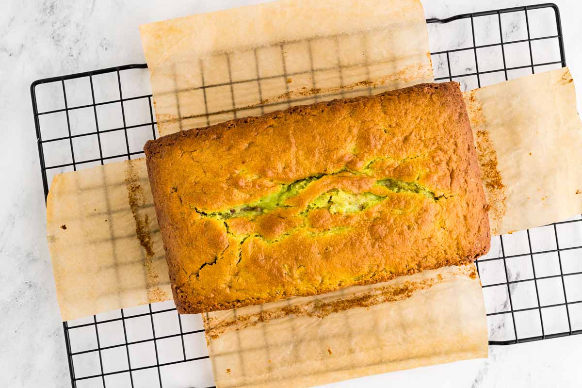 overhead view of baked pistachio bread on wire rack