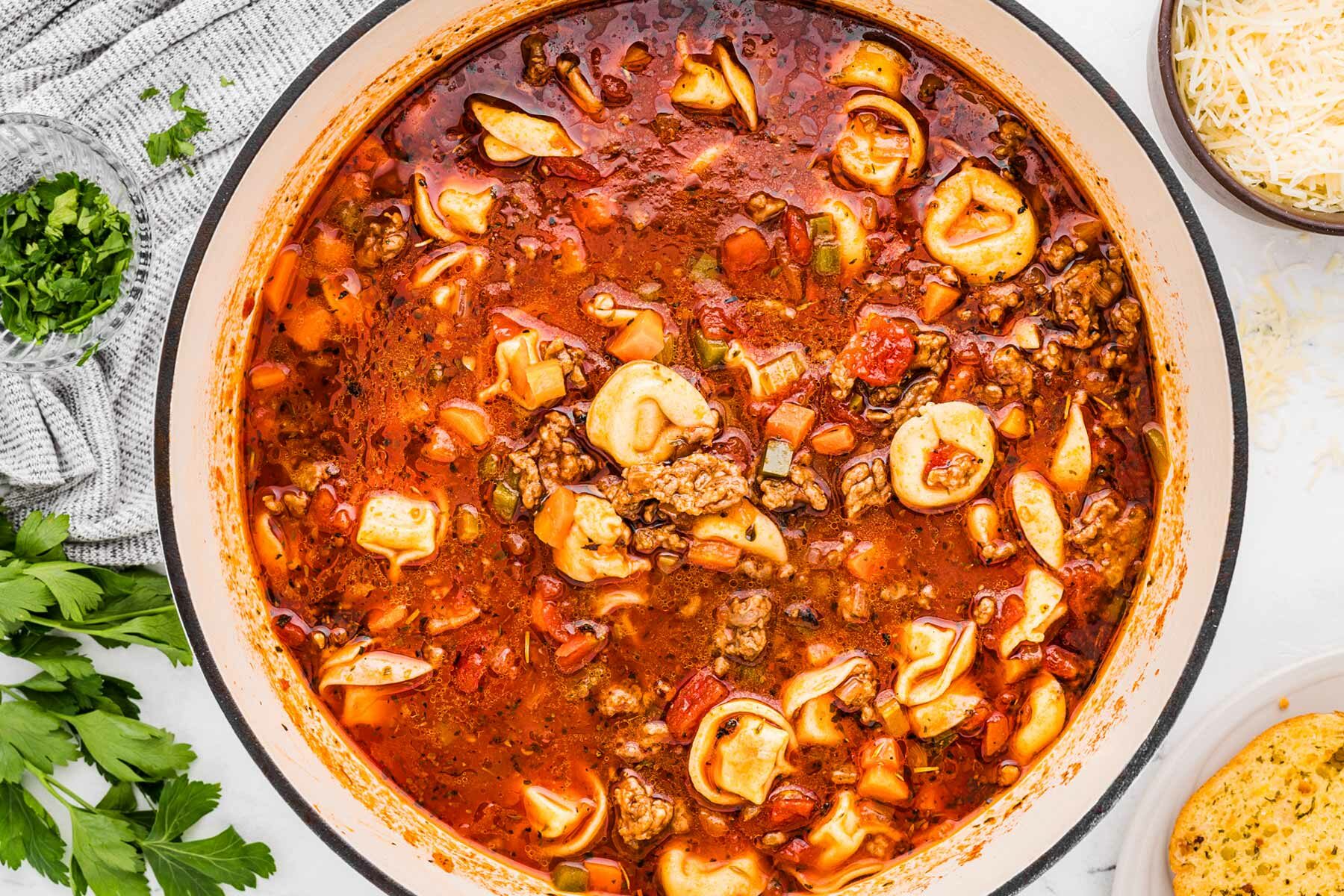 overhead view of pot filled with sausage tortellini soup