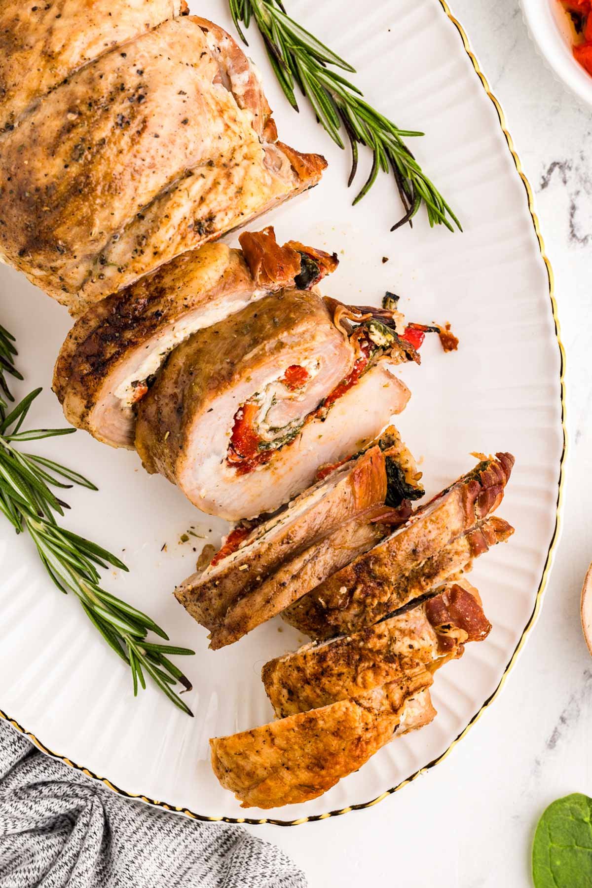 overhead view of stuffed pork loin on serving platter