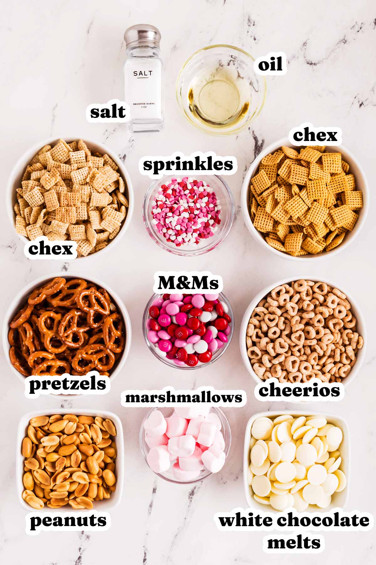 overhead view of ingredients to make a Valentine's treat mix with text labels