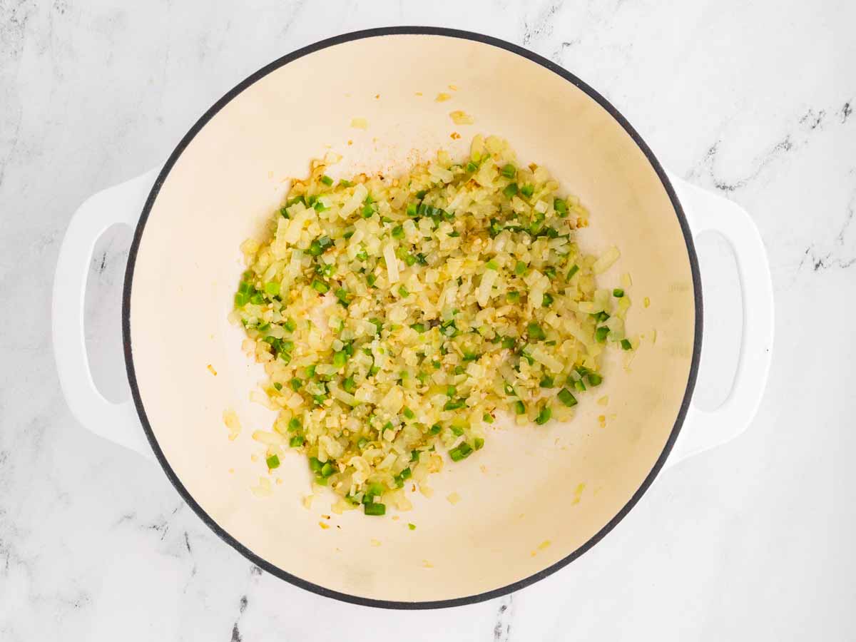 overhead view of sautéed onion, jalapeño and garlic in pot