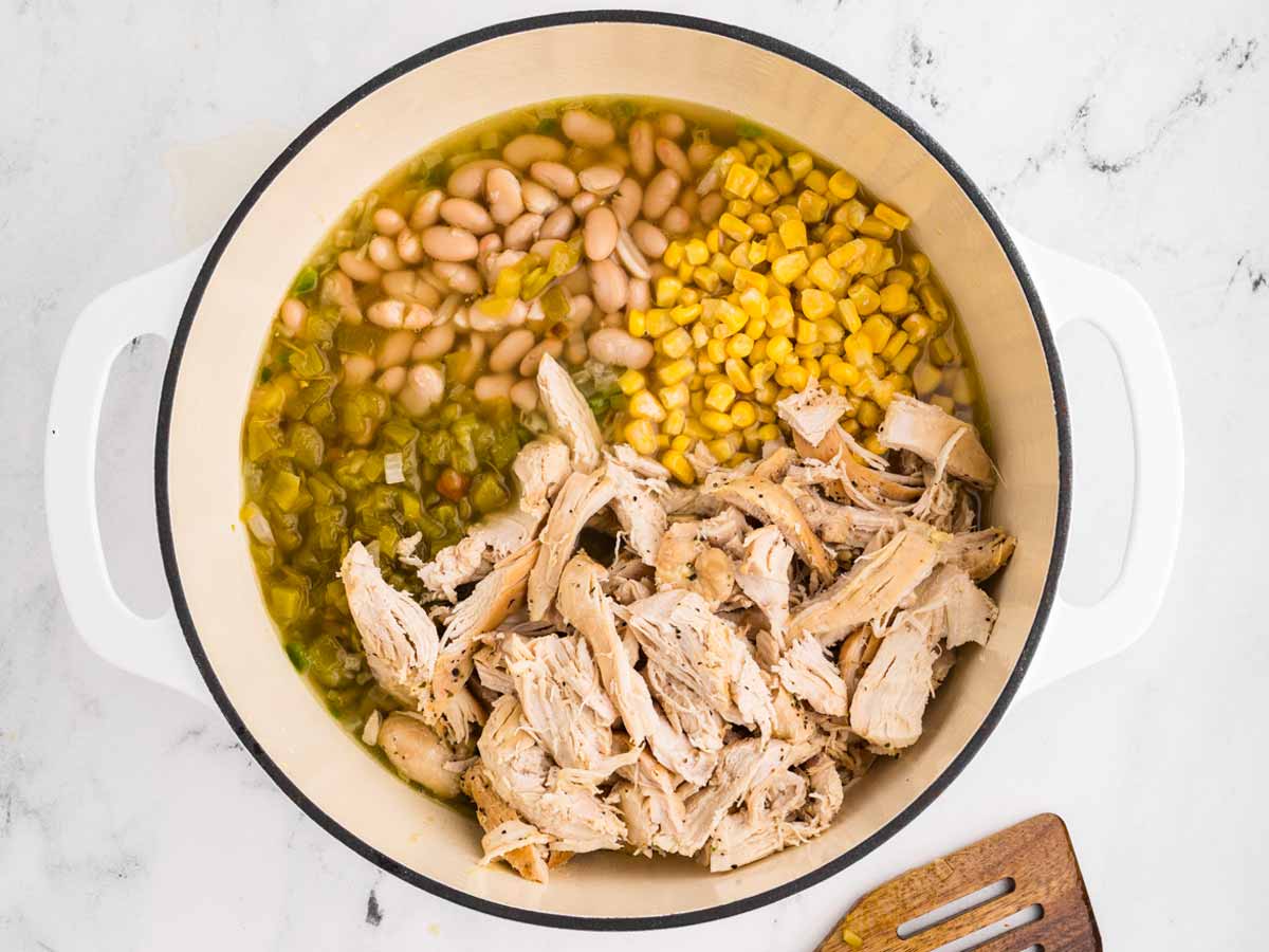 overhead view of ingredients for white chicken chili in white pot