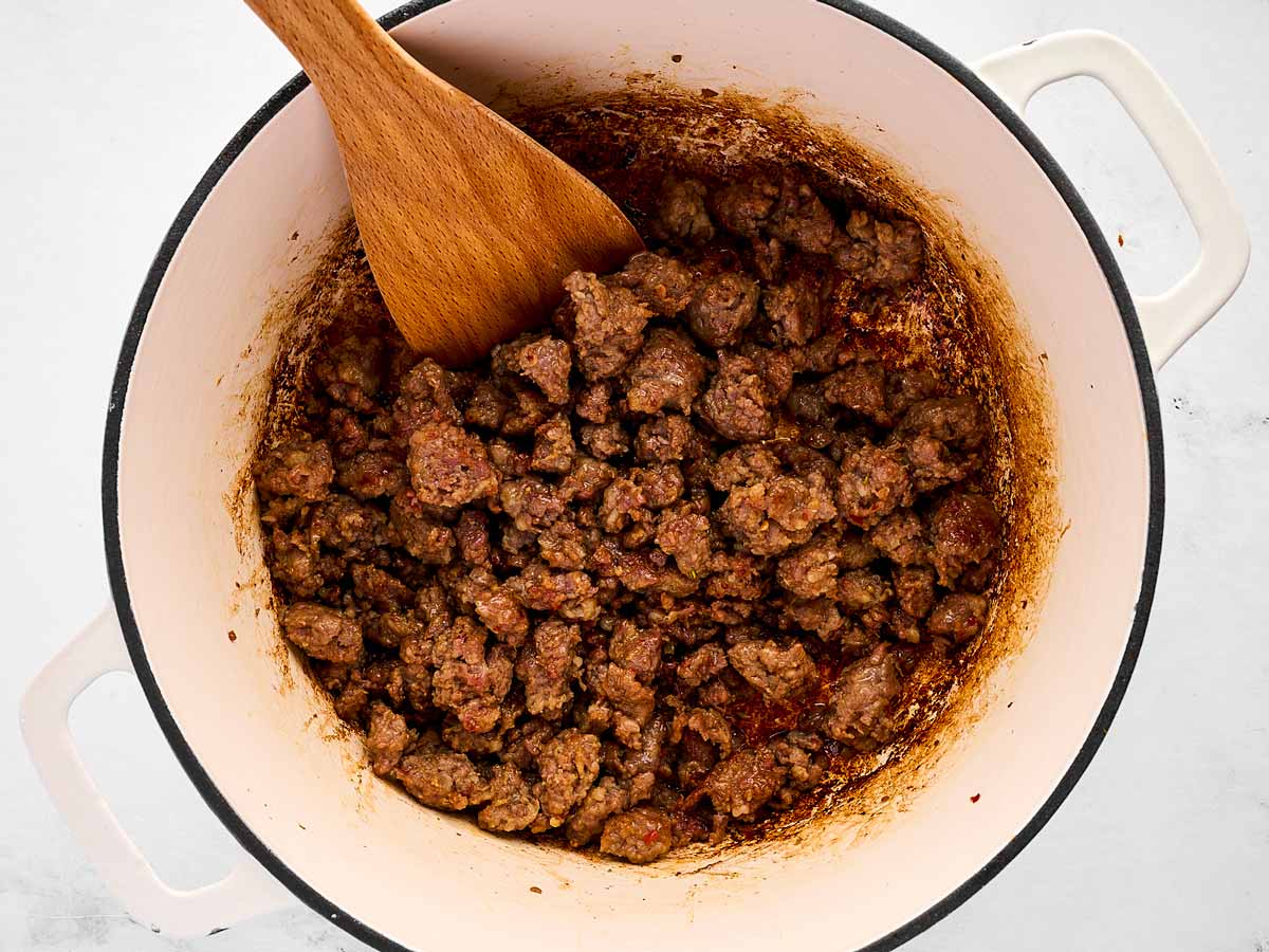 overhead view of browned sausage in pot