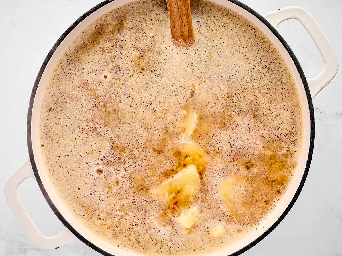 overhead view of broth and potatoes in pot