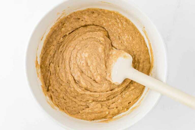 overhead view of banana bread batter in bowl