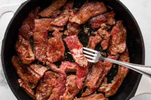 overhead view of beef flank steak being browned