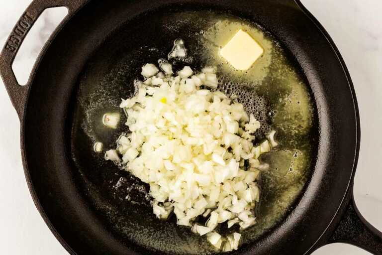 overhead view of raw onion in skillet with butter