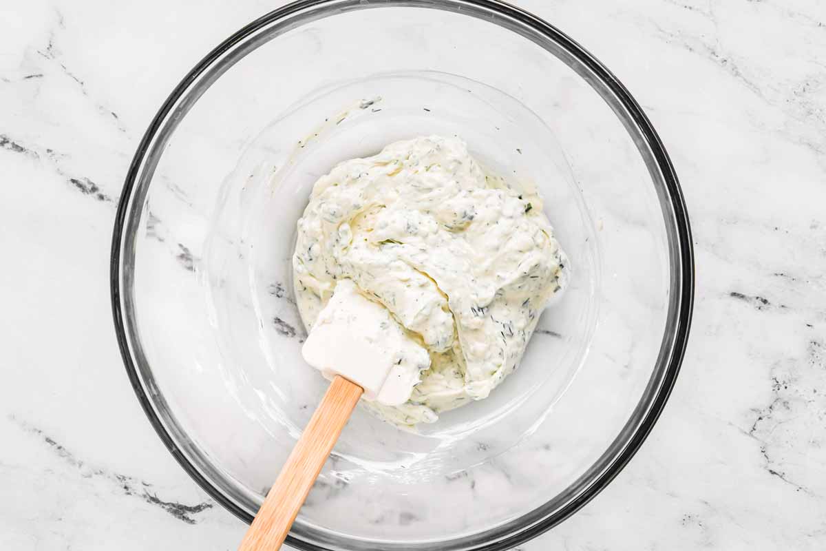 herb cream filling in bowl with spatula