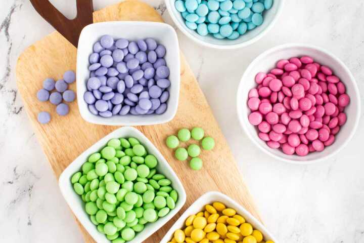 overhead view of color sorted pastel m&ms in bowls