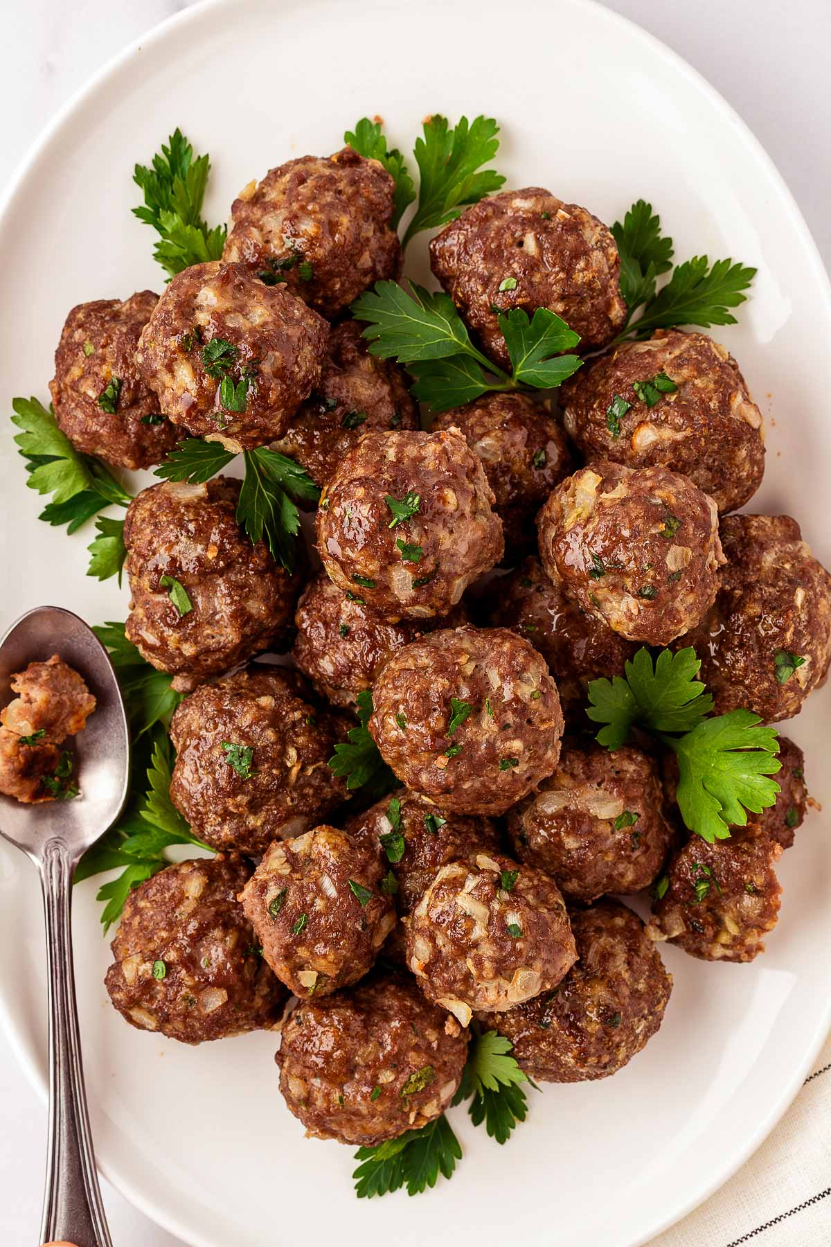 overhead view of baked meatballs on oval platter