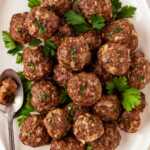 overhead view of baked meatballs on oval platter