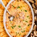 overhead view of hot reuben dip in white baking dish with spoon stuck in