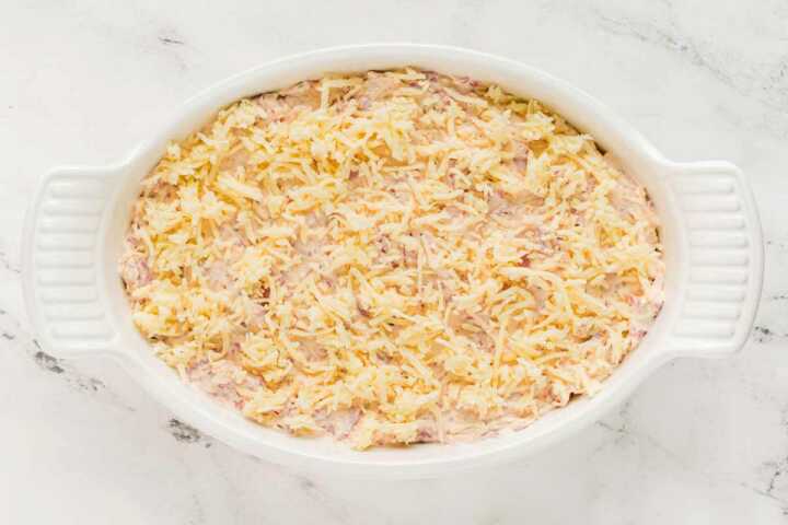 overhead view of unbaked reuben dip in white baking dish