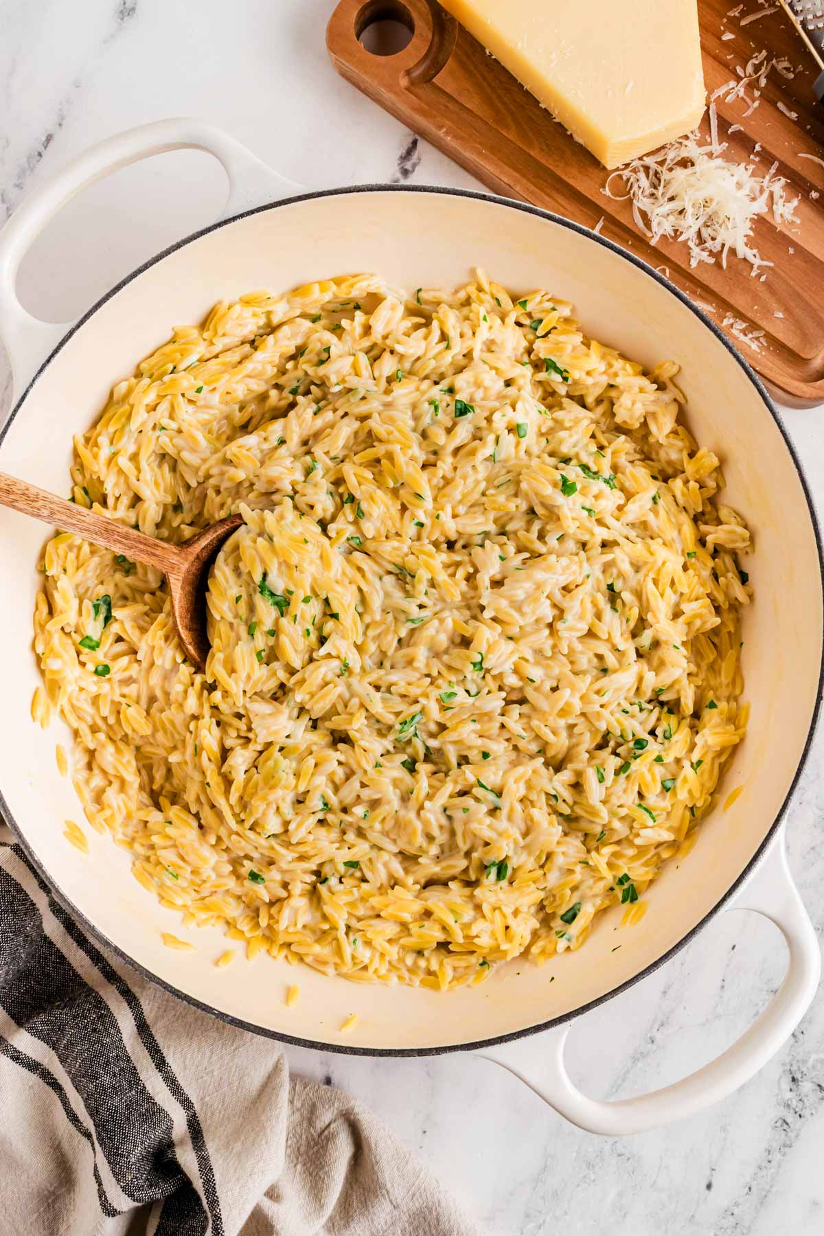 overhead view of garlic parmesan orzo in cast iron pan