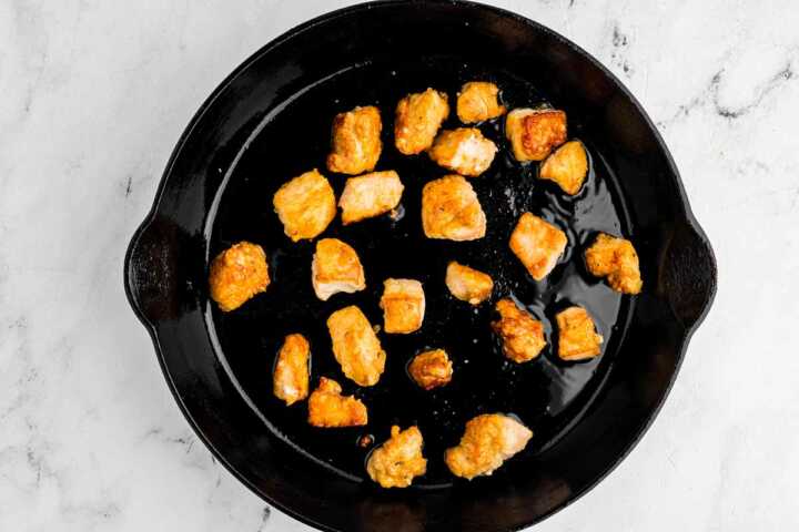 overhead view of seared chicken in skillet