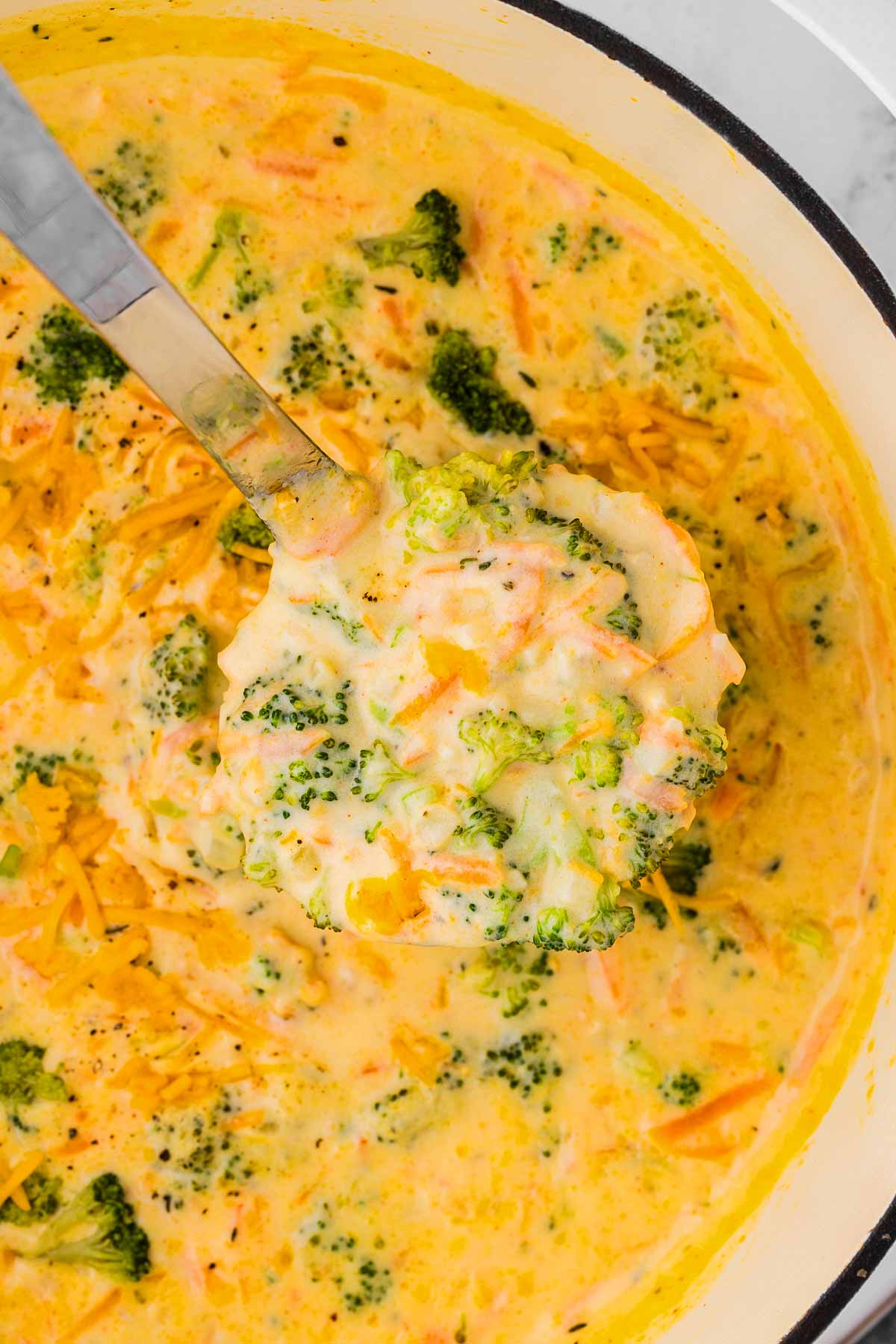 Broccoli cheddar soup on soup ladle