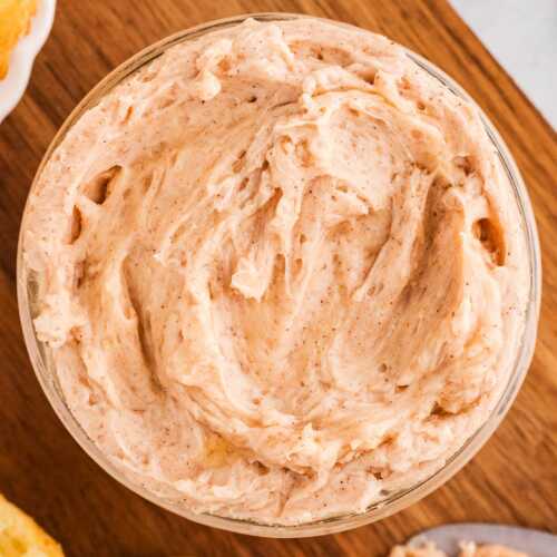 overhead view of cinnamon butter in mason jar on wooden board