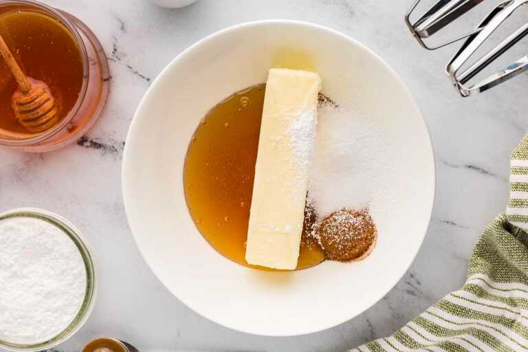 overhead view of ingredients to make honey cinnamon butter in bowl