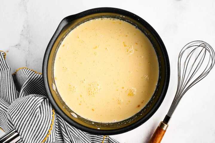 overhead view of ingredients for vanilla sauce in saucepan before cooking