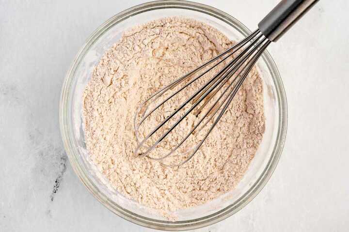 overhead view of flour mix in bowl with whisk