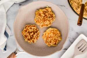 overhead view of cooked potato pancakes in skillet