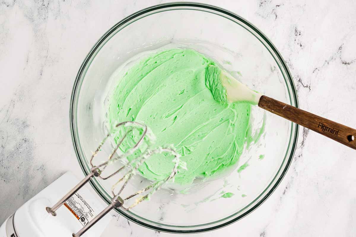 Green peppermint frosting in a glass bowl