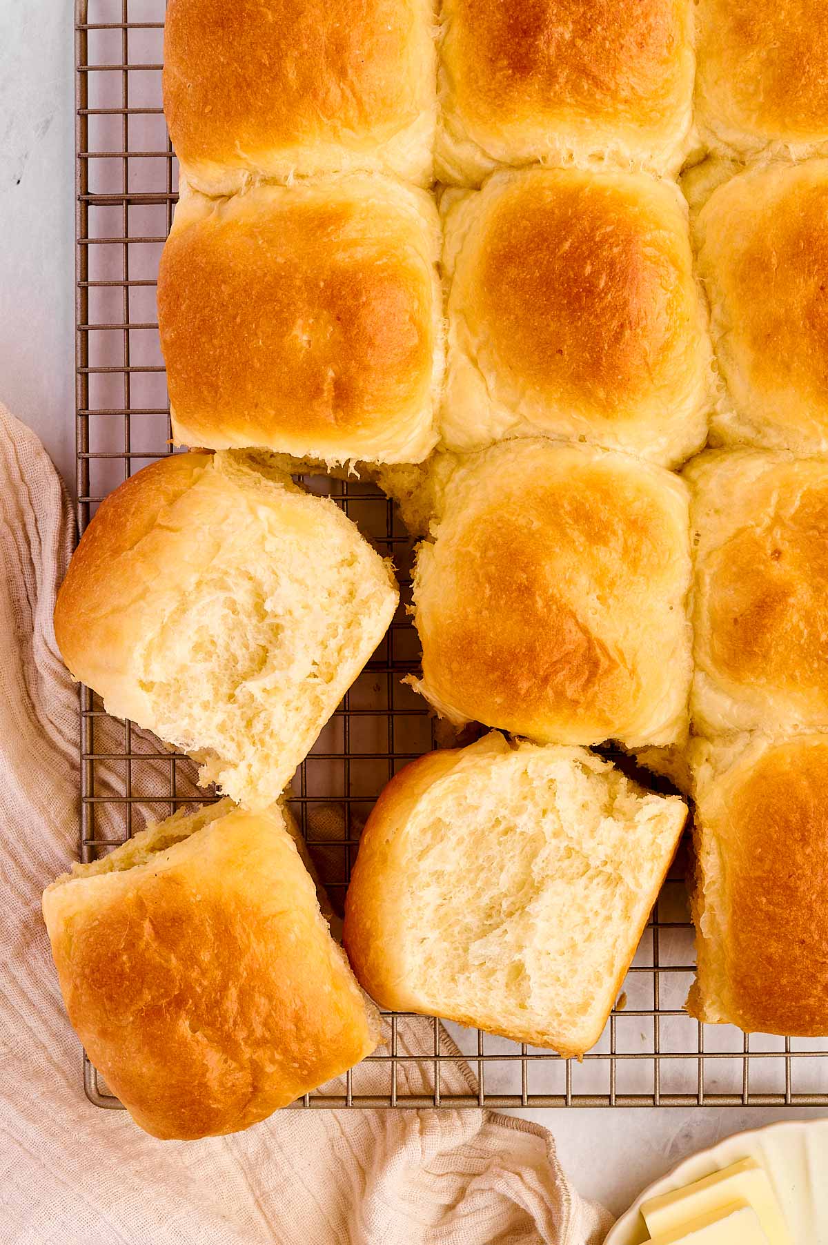 overhead view of potato dinner rolls on a wire rack